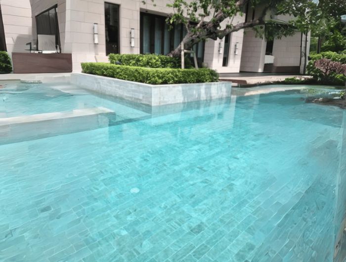 Natural Bali Ocean Wave Stone tiles installed in a swimming pool, highlighting elegant tropical color.