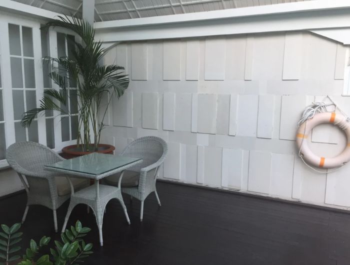 Limestone wall cladding for house exterior, featuring soft beige tones and smooth natural texture, ideal for modern and tropical home designs.